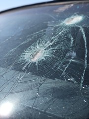 close view of shattered, broken windshield after a car crash