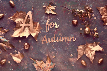 Autumn flat lay, top view with painted golden leaves and text 