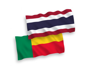National vector fabric wave flags of Benin and Thailand isolated on white background. 1 to 2 proportion.