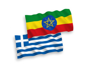 National vector fabric wave flags of Greece and Ethiopia isolated on white background. 1 to 2 proportion.