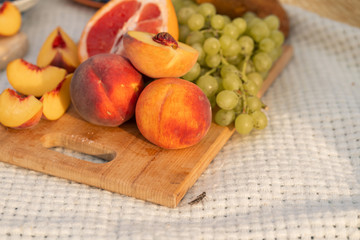 Close-up of a bouquet of fresh fruits on a cutting board. Picnic outside