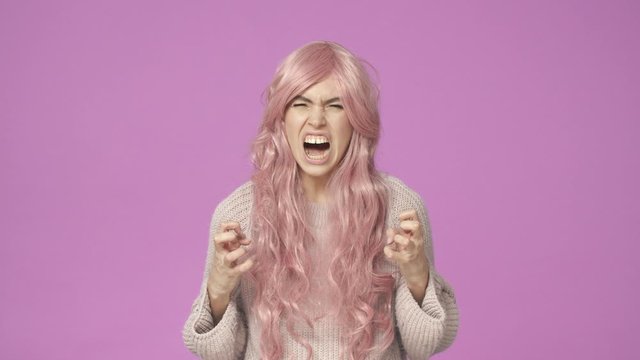 Im gonna kill you. Slow-motion outraged, pissed-off intense and pressured woman in pink wig, clench hands in fists furious, yelling, squinting angry, look hateful, want strangle someone