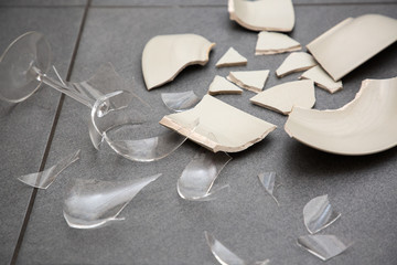 Broken Plate or broken water glass on the on the floor in the kitchen The concept of accidents in...