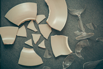 Broken Plate or broken water glass on the on the floor in the kitchen The concept of accidents in...