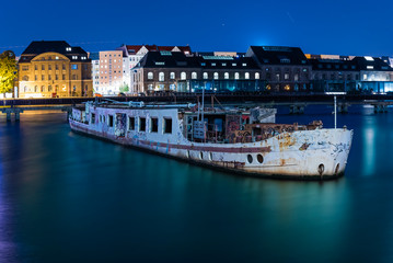 Old big boat that ran aground, an old boat lies on the ground, night shot, colorful, Berlin, Treptow harbor