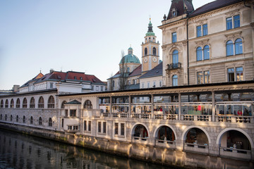 Fototapeta na wymiar View of Ljubljana cathedral from the central market and river side of the city
