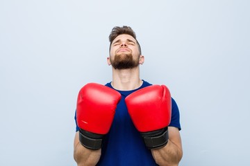 Young caucasian man wearing a boxing gloves