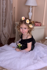 cute little girl with a crown of flowers on her head