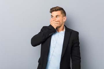 Young handsome caucasian man thoughtful looking to a copy space covering mouth with hand.