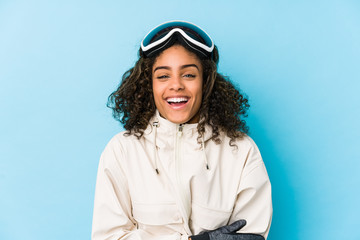 Young african american skier woman isolated laughing and having fun.