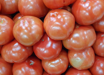 Fresh red tomatoes in a supermarket. Tomato texture, background. Copy space.