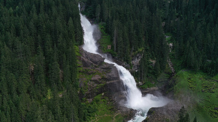 Aerial view of Krimml waterfall, cascades. Landscape with spruces, fir tree forest, stones, water flowing from mountains. Salzburg land, Austria.