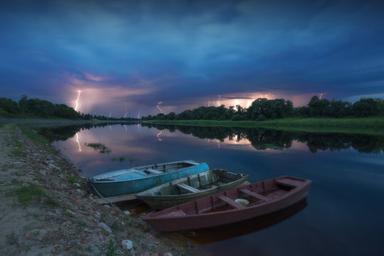 A lot of lightning over the river, in the foreground of the boat.