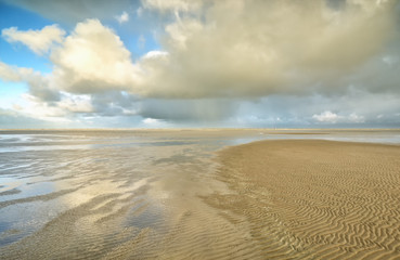 Fototapeta na wymiar dramatic clouds over North sea beach