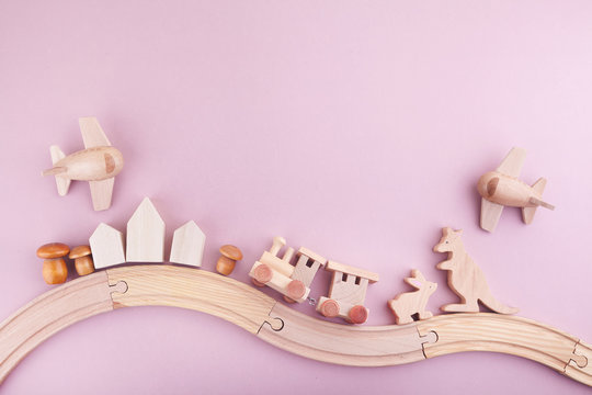 Zero waste. Eco wooden toys on pink background. Flat lay. Top view