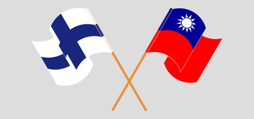 Crossed and waving flags of Taiwan and Finland