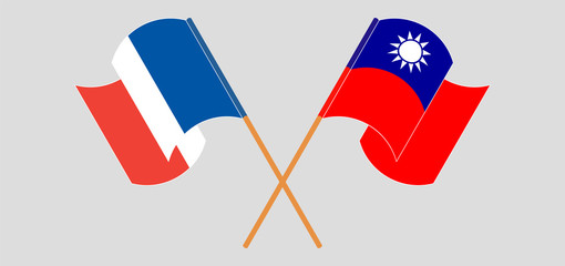 Crossed and waving flags of Taiwan and France