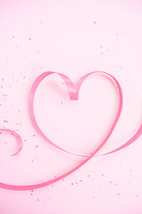 Ribbon heart. Soft pastel background to Valentine`s Day. Light pink sparkles. Flat lay. Valentines Day 2021. Romantic wallpaper. Stories background template. Banner lovers day sale. Wedding invitation