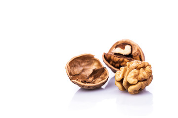 Walnuts and cracked walnut on white background