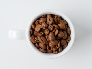 Roasted coffee beans in the cup.