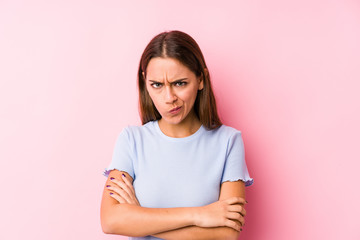 Fototapeta premium Young caucasian woman wearing a ski clothes isolated frowning face in displeasure, keeps arms folded.