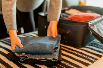 Woman unpacking suitcase