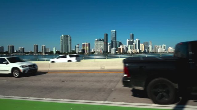 View of city from causeway bridge with cars in motion