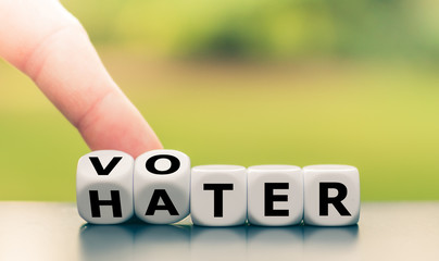 Be a voter and not a hater. Hand turns a dice and changes the word "hater" to "voter".