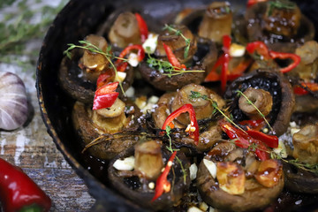 Large champignons baked with chili pepper and spices. Vegan dish. Healthy lunch with champignons. Selective focus. Macro.