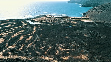 sunset between mountains cliffs and desert landscapes