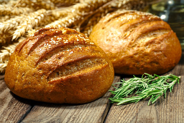 loaf of bread on wooden background, food closeup.Fresh homemade bread.French bread. Bread at...