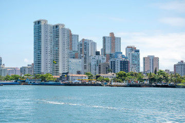 Fototapeta na wymiar Brazilian coastal city of Santos SP. View of the the city by the sea, and the car ferry access on the coast.