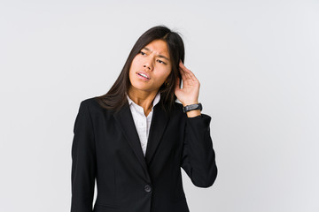 Fototapeta na wymiar Young asian business woman trying to listening a gossip.