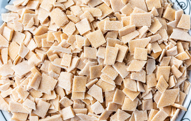 Turkish pasta (eriste) in a bowl isolated on white. Cut dough ready to bake.