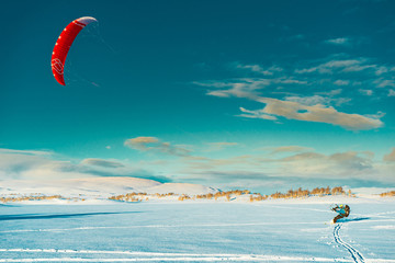 A man is kiting in winter mountain in Norway