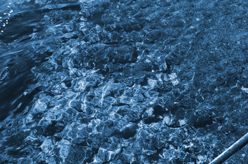 Blue sea water surface. Swimming pool water texture. Blue liquid reflections photo wallpaper. Still rippled water of seashore. Classic Blue color. Color of the year 2020. Trendy color.