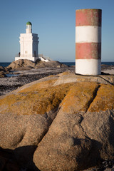 St Helena Bay, Cape Town, South Africa - August 26 2017: White Light House on the beach with ocean and rocks in the foreground in St Helena Bay West Coast Cape Town South Africa