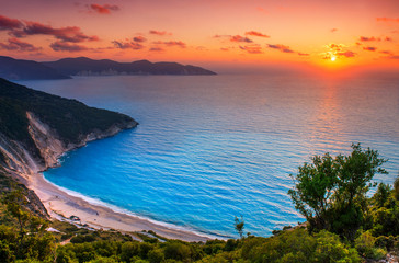Fototapeta na wymiar Beautiful summer sunset on Mirtos beach in Greece