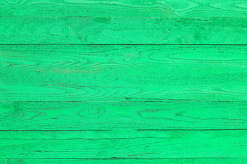 Light green wooden fence made of pine boards, green wall background, pine wood texture