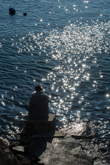 Man sitting and contemplating on beach.  Concept of freedom relaxation.
