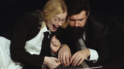 Mobile phone or smartphone devices. Office romance. Attractive girl typing on computer having fun online or chatting with friend. Young business couple talking with client in call center.