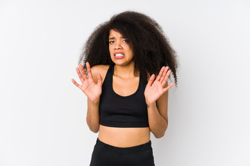 Young african american sporty woman rejecting someone showing a gesture of disgust.