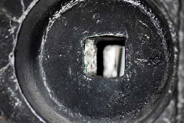 old steel locomotive wheel with open square in the middle 