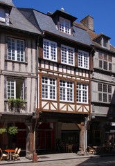 Half-timbered side-gabled residential houses with arcades in the old town of Dinan, Brittany in France