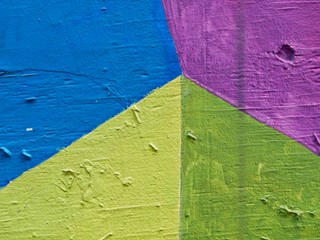 Green, yellow, and blue paint on textured, wooden wall in downtown Austin, Texas for abstract background. © skyoftexas