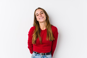 Young caucasian woman posing isolated  laughs and closes eyes, feels relaxed and happy.