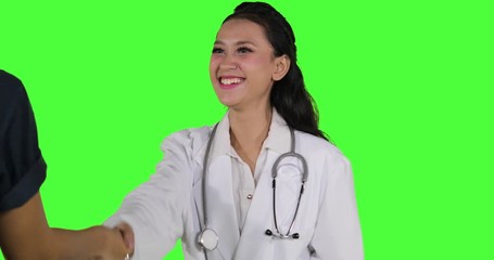 Doctor shaking hands with her patient on studio