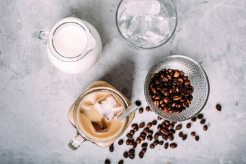 Obraz na płótnie Canvas Iced coffee with milk in vintage jar with ingredients