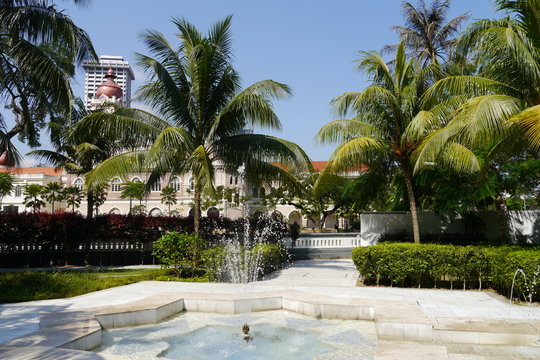 Park mit Springbrunnen, Hecken und Palmen Jamek Moschee Kuala Lumpur