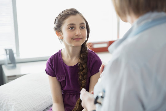 Pediatrician talking with patient in office